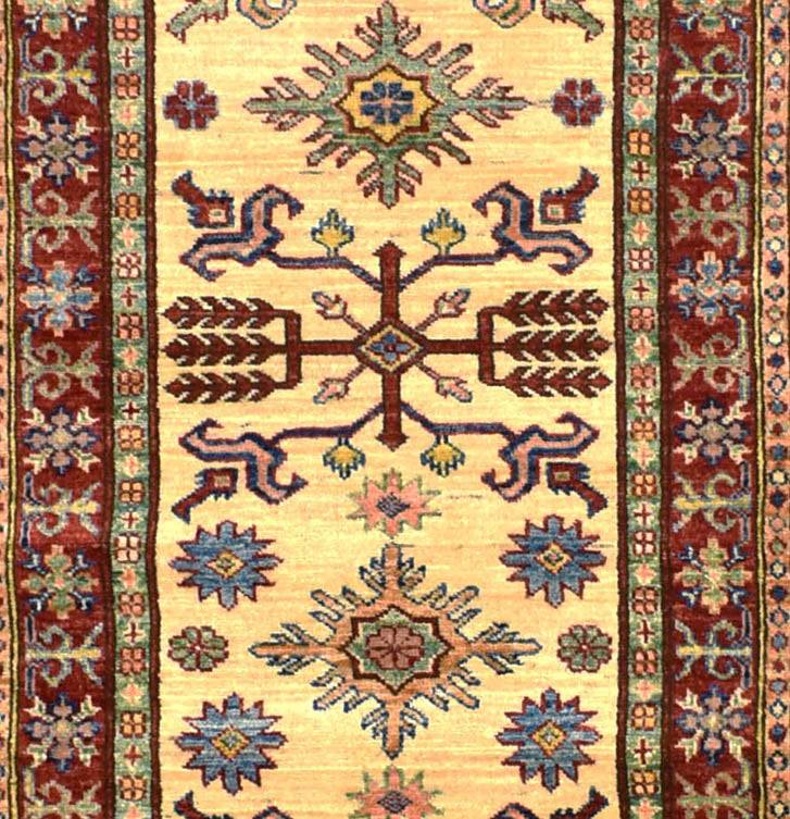 Handmade Afghan Super Kazakh runner rug featuring geometric tribal motifs on a cream background.