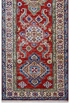 Handmade Afghan Super Kazakh runner rug featuring geometric medallions on a red wool field.