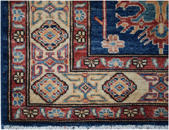 A handmade Afghan Super Kazakh runner featuring a geometric pattern in blue, red, and cream.