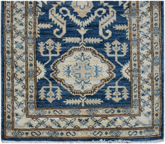 An Afghan Super Kazakh runner rug featuring traditional geometric motifs in blue and cream wool.