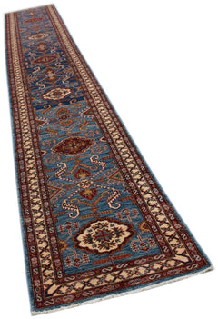 A long, handmade Afghan Super Kazakh runner rug featuring traditional geometric motifs in blue.