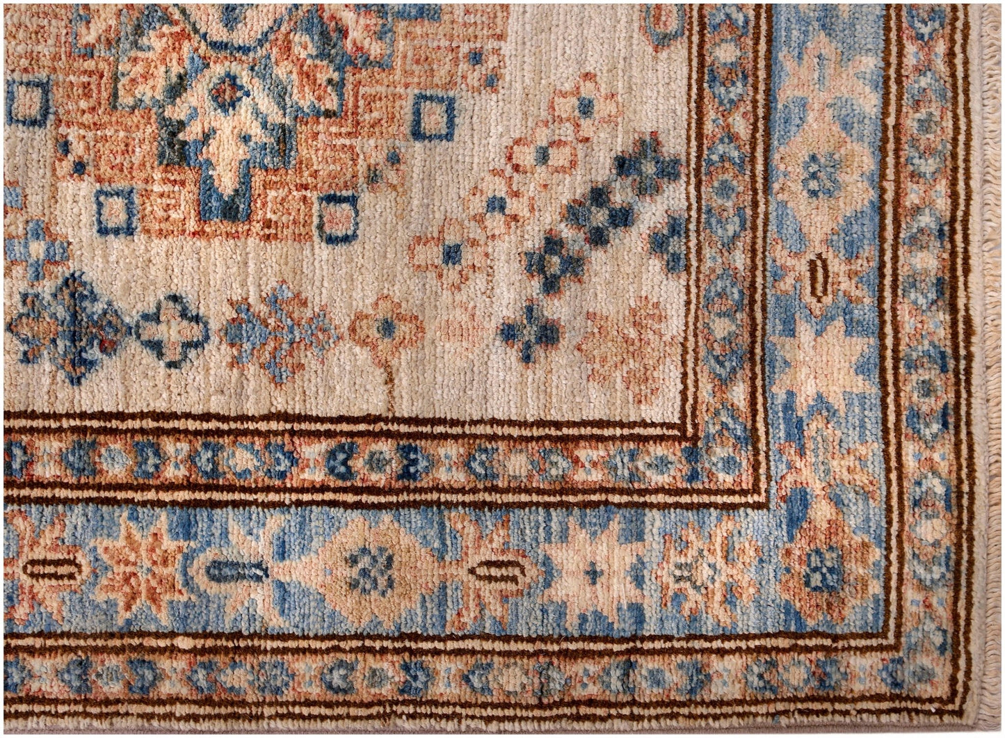 An Afghan Super Kazakh runner featuring traditional geometric motifs in blue, cream, and rust tones.