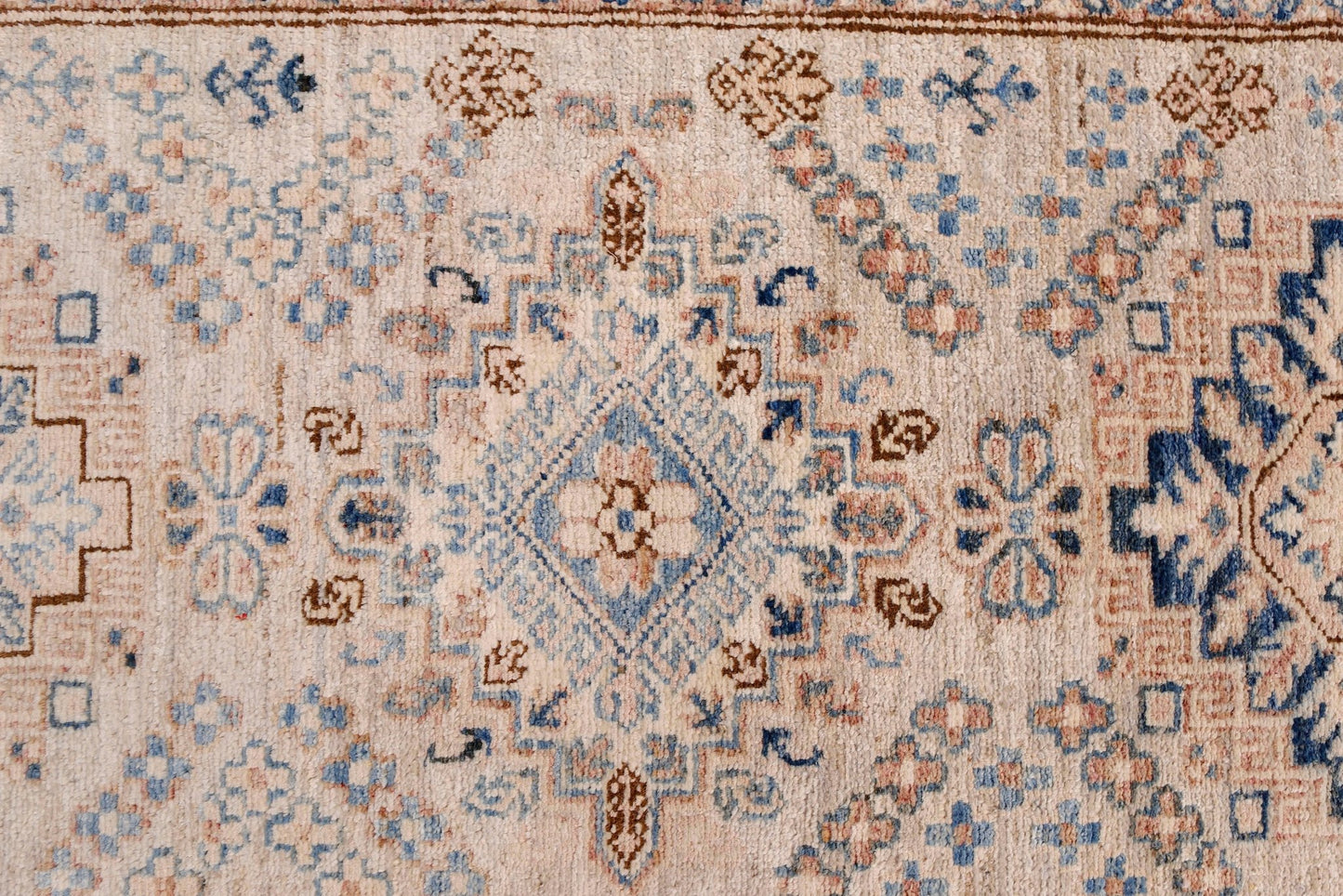 An Afghan Super Kazakh runner featuring traditional geometric motifs in blue, brown, and cream.