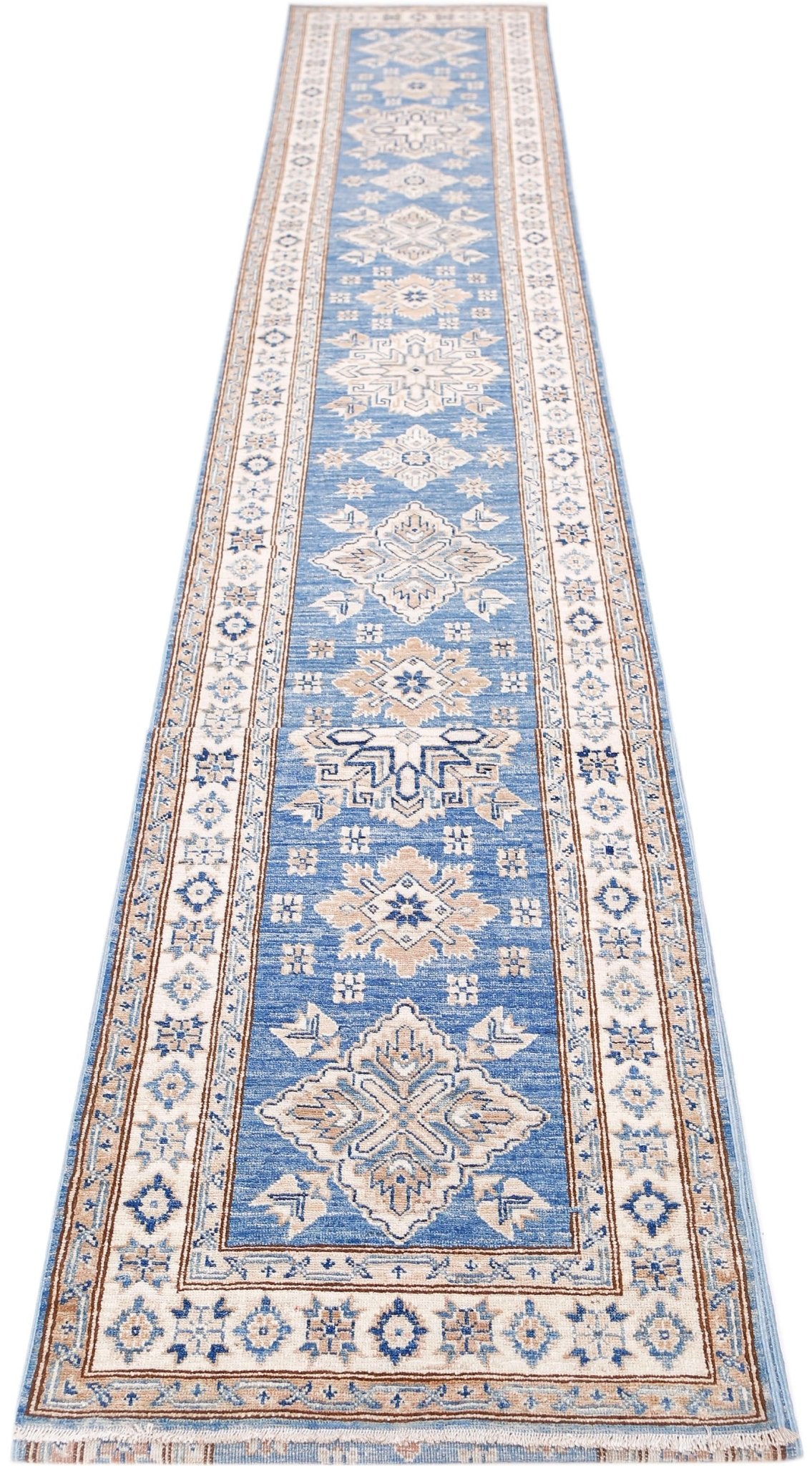 A long, handmade Afghan Super Kazakh runner rug featuring traditional geometric motifs in blue and beige.