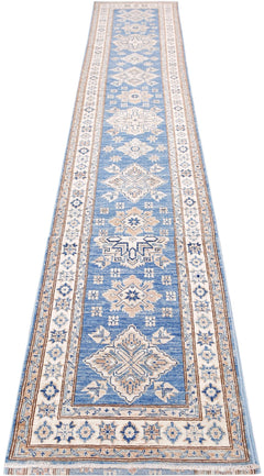 A long, handmade Afghan Super Kazakh runner rug featuring traditional geometric motifs in blue and beige.