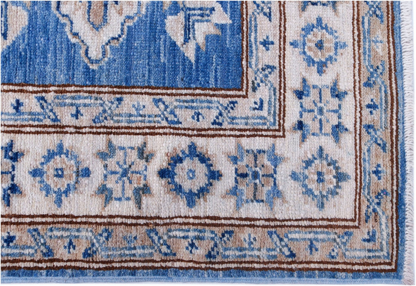 A handmade Afghan Super Kazakh runner featuring traditional blue and beige geometric motifs.