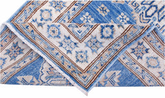 An Afghan Super Kazakh runner featuring traditional blue and beige geometric patterns.