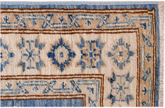 A close-up of an Afghan Super Kazakh runner featuring traditional blue and beige geometric motifs.