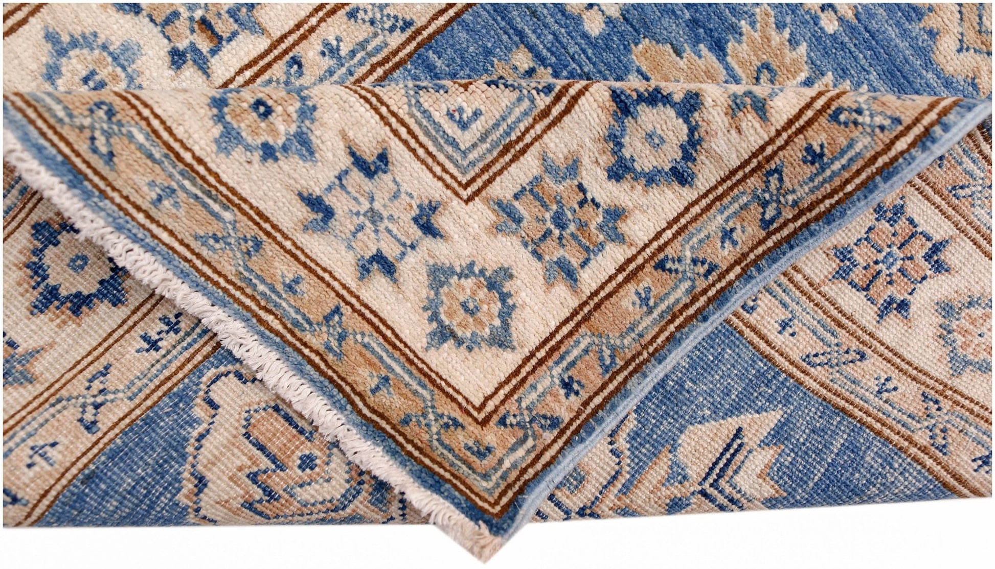 A folded Afghan Super Kazakh runner featuring traditional blue and beige geometric patterns.