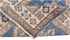 A folded Afghan Super Kazakh runner featuring traditional blue and beige geometric patterns.