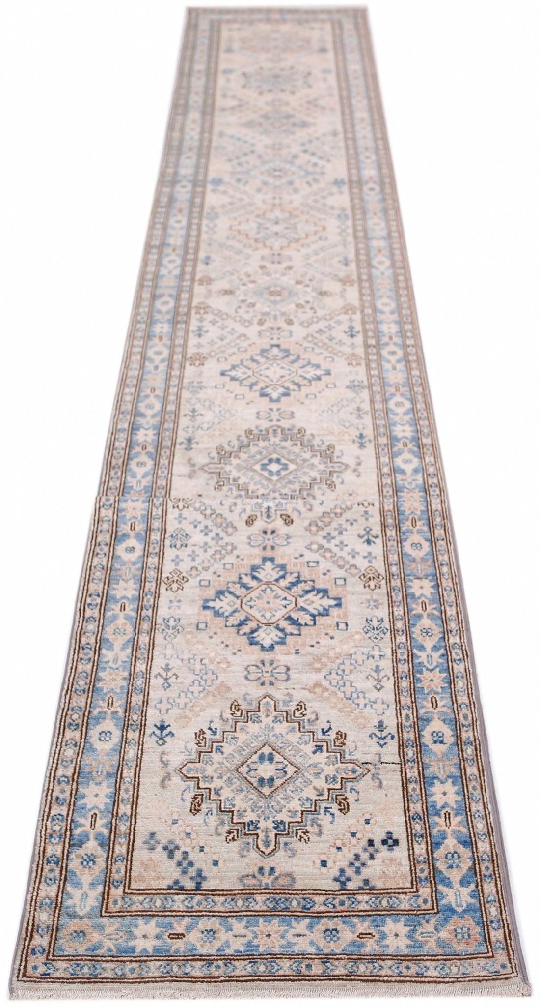 A long, handmade Afghan Super Kazakh runner rug featuring traditional blue and beige geometric motifs.