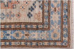 A handmade Afghan Super Kazakh runner featuring traditional blue and beige geometric floral motifs.