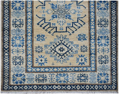 Handmade Afghan Super Kazakh runner rug featuring traditional blue geometric motifs on a beige base.