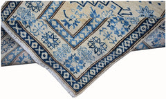 An Afghan Super Kazakh runner rug featuring traditional blue geometric patterns on a cream base.