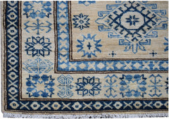Handmade Afghan Super Kazakh runner rug featuring blue geometric patterns on a beige wool field.