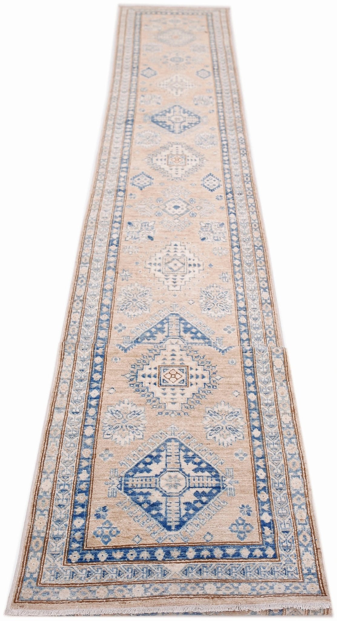 A long, handmade Afghan Super Kazakh runner rug featuring traditional blue geometric motifs on a beige background.