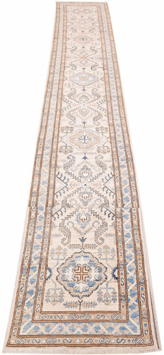A long, handmade Afghan Super Kazakh runner rug featuring traditional geometric motifs in blue and tan.