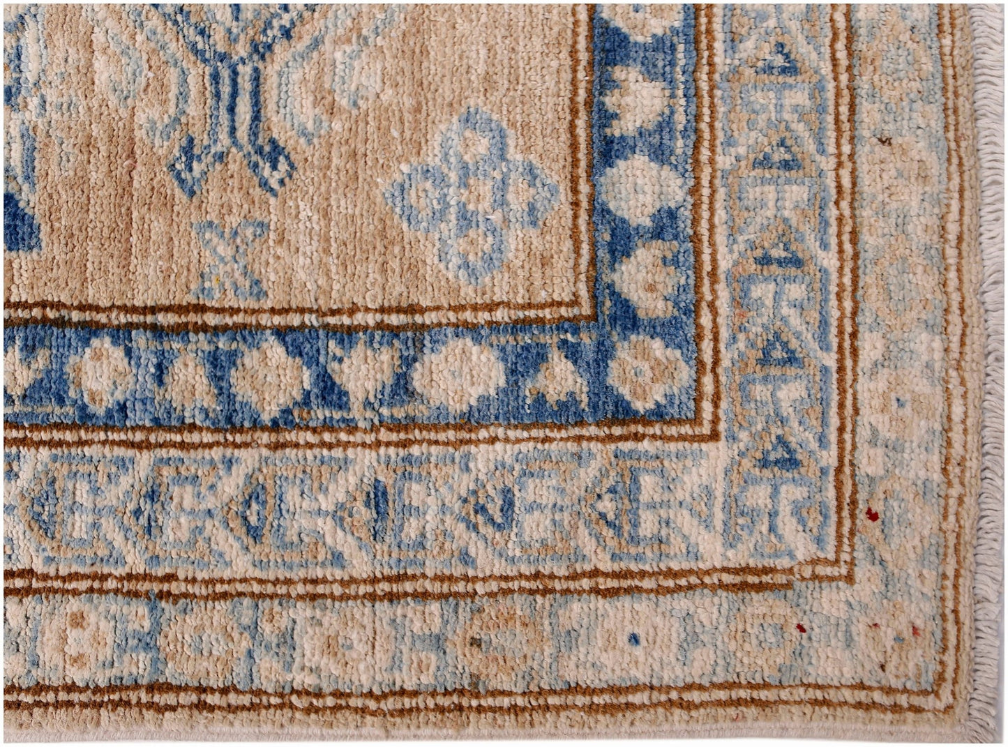A handmade Afghan Super Kazakh runner featuring traditional blue and beige geometric patterns.