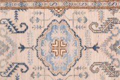 A hand-knotted Afghan Super Kazakh runner featuring a central blue medallion on a cream field.