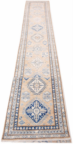 A long, handmade Afghan Super Kazakh runner featuring traditional blue geometric motifs on beige.