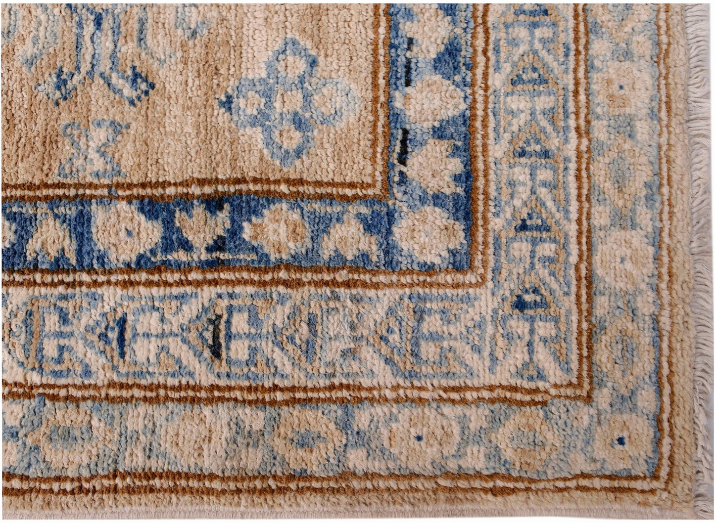 A handmade Afghan Super Kazakh runner featuring traditional blue and beige geometric patterns.