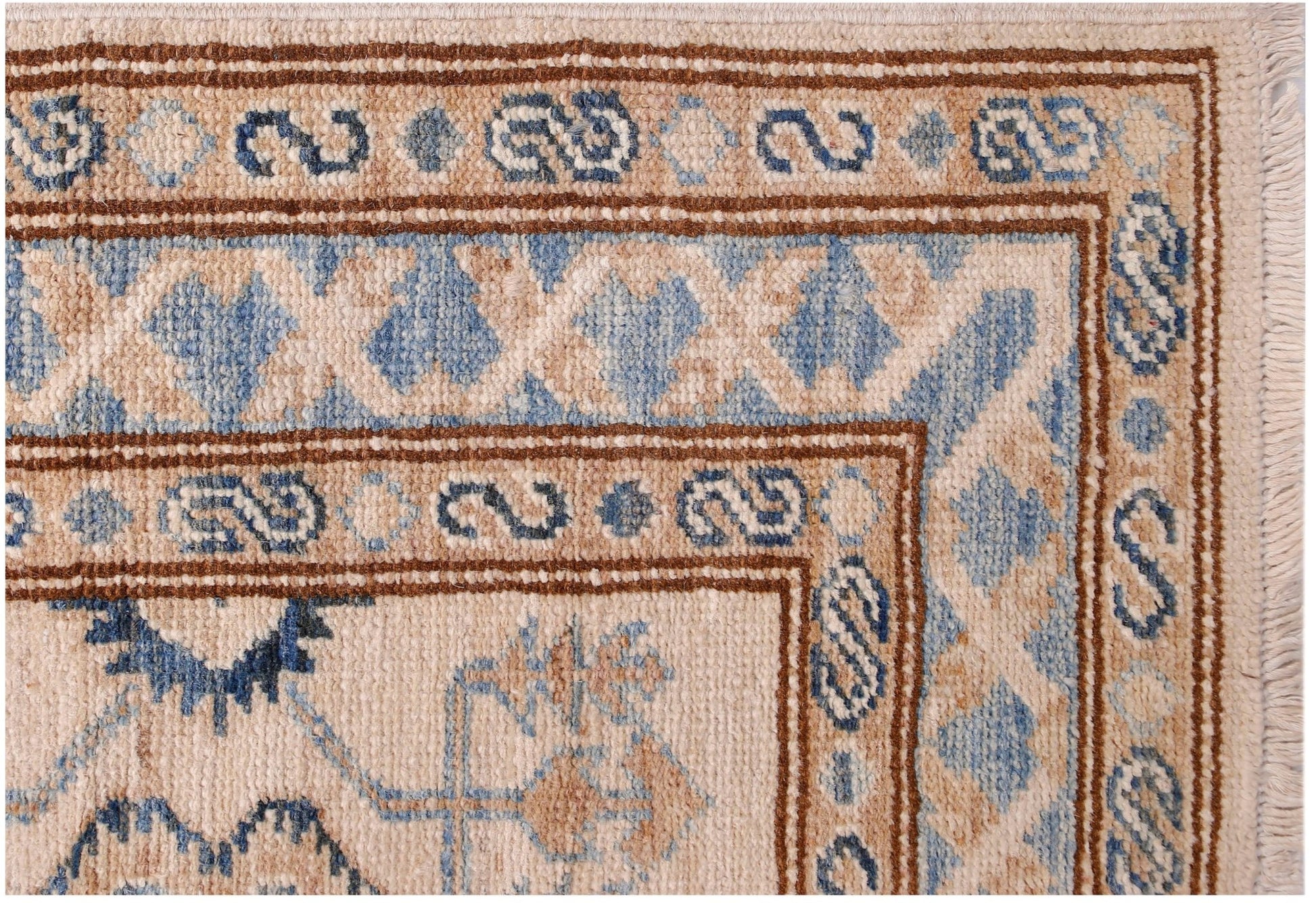 A close-up of an Afghan Super Kazakh runner featuring traditional blue and beige geometric patterns.