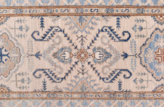 An Afghan Super Kazakh runner featuring traditional blue and tan geometric motifs on a cream field.