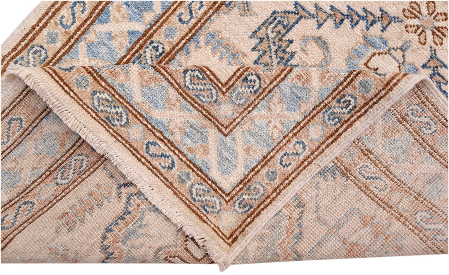 A folded Afghan Super Kazakh runner featuring traditional blue and brown geometric patterns.