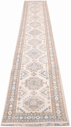 An Afghan Super Kazakh runner rug featuring traditional geometric motifs in blue and beige tones.
