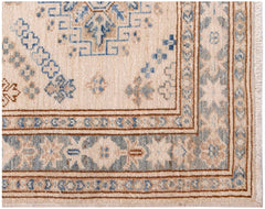 A handmade Afghan Super Kazakh runner featuring traditional blue and tan geometric motifs.