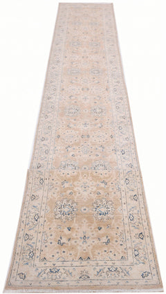 A long, handmade Afghan Super Kazakh runner rug featuring traditional blue motifs on a beige base.