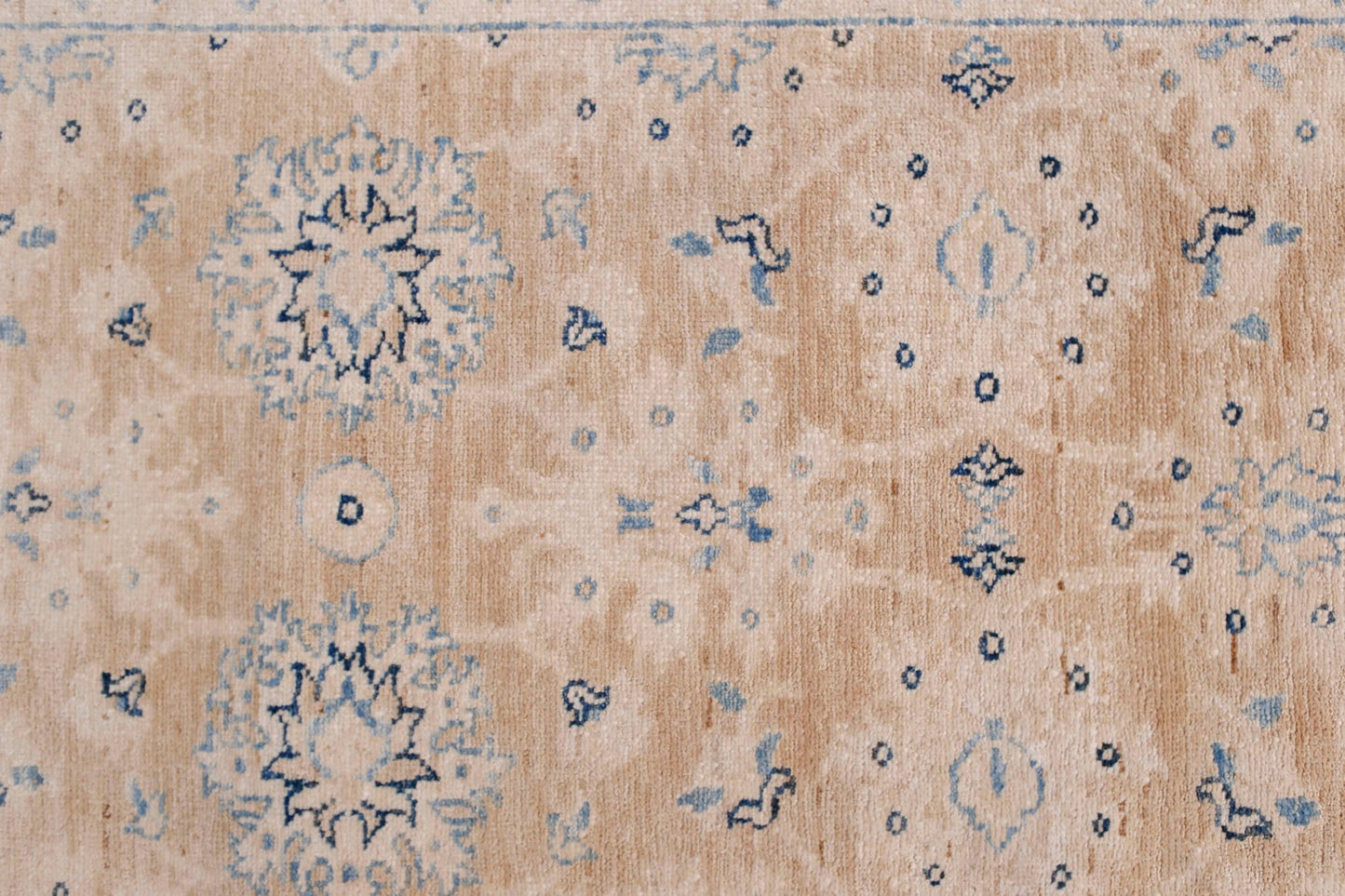 An Afghan Super Kazakh runner featuring traditional blue geometric motifs on a beige wool field.