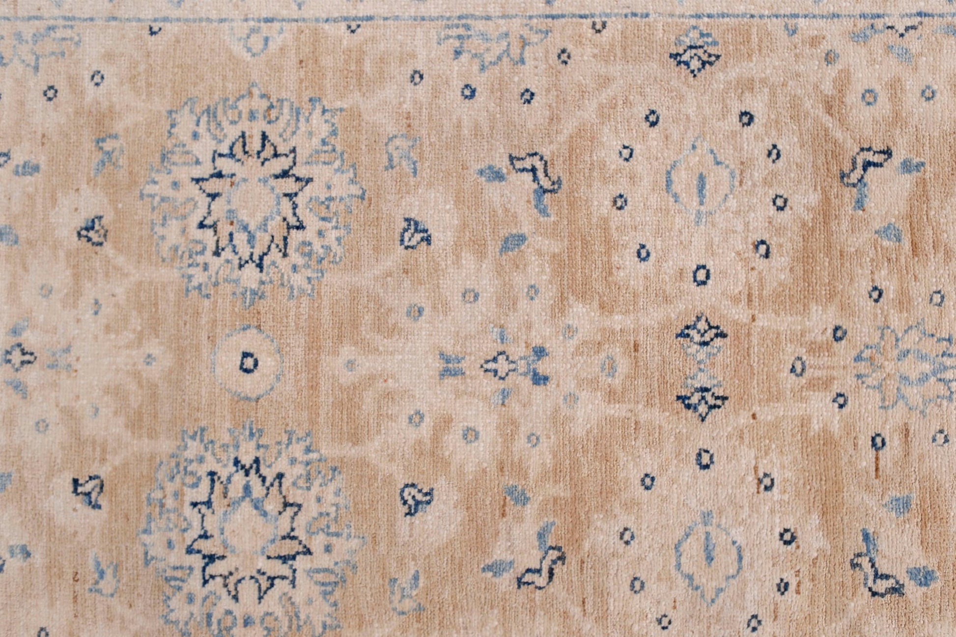 An Afghan Super Kazakh runner featuring traditional blue geometric motifs on a beige wool field.