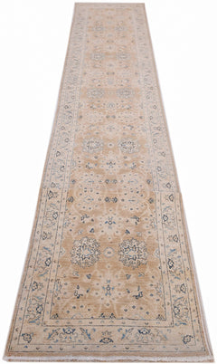 A long, handmade Afghan Super Kazakh runner rug featuring traditional blue and cream floral motifs.