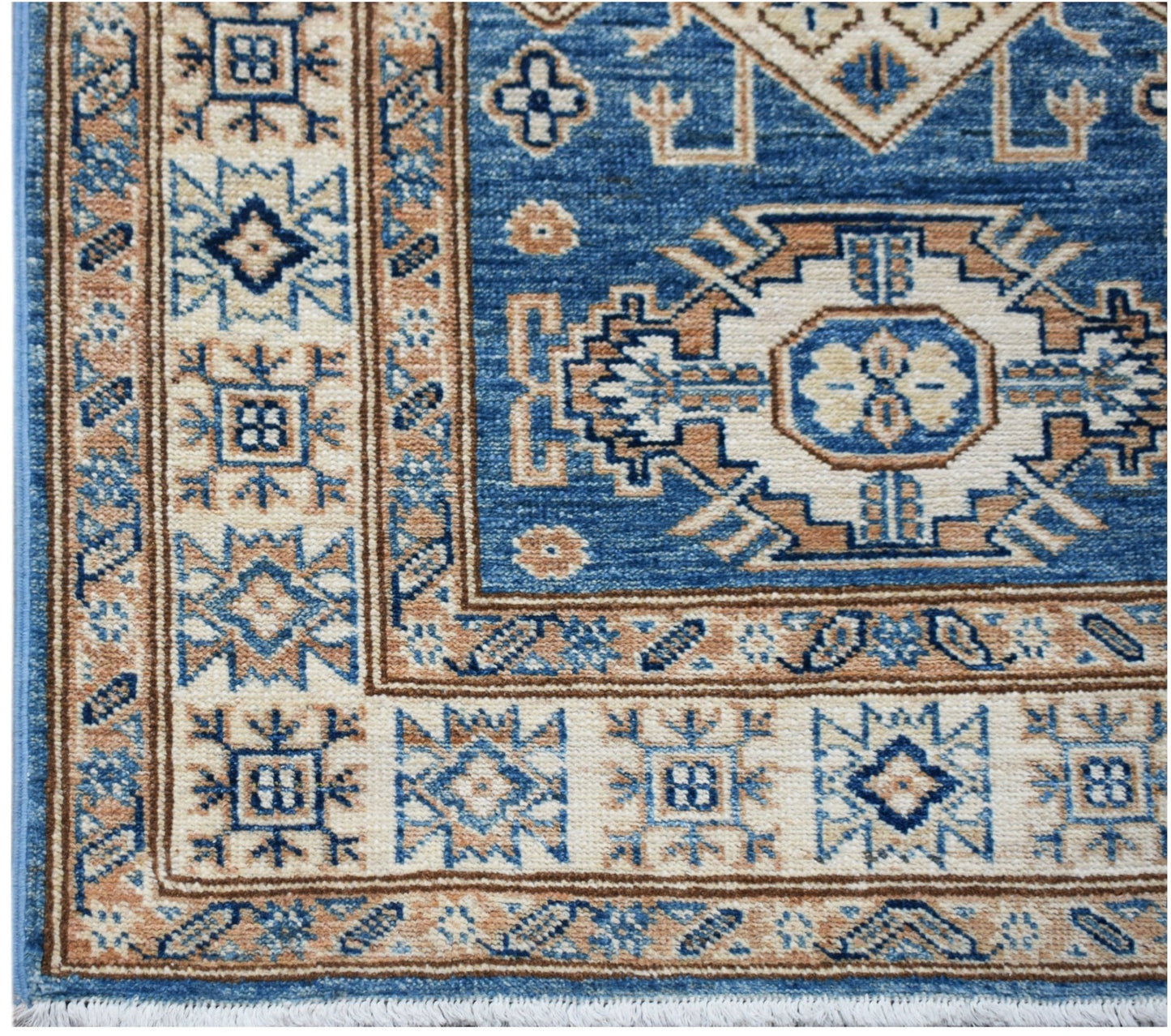 A handmade Afghan Super Kazakh runner featuring traditional blue and beige geometric motifs.