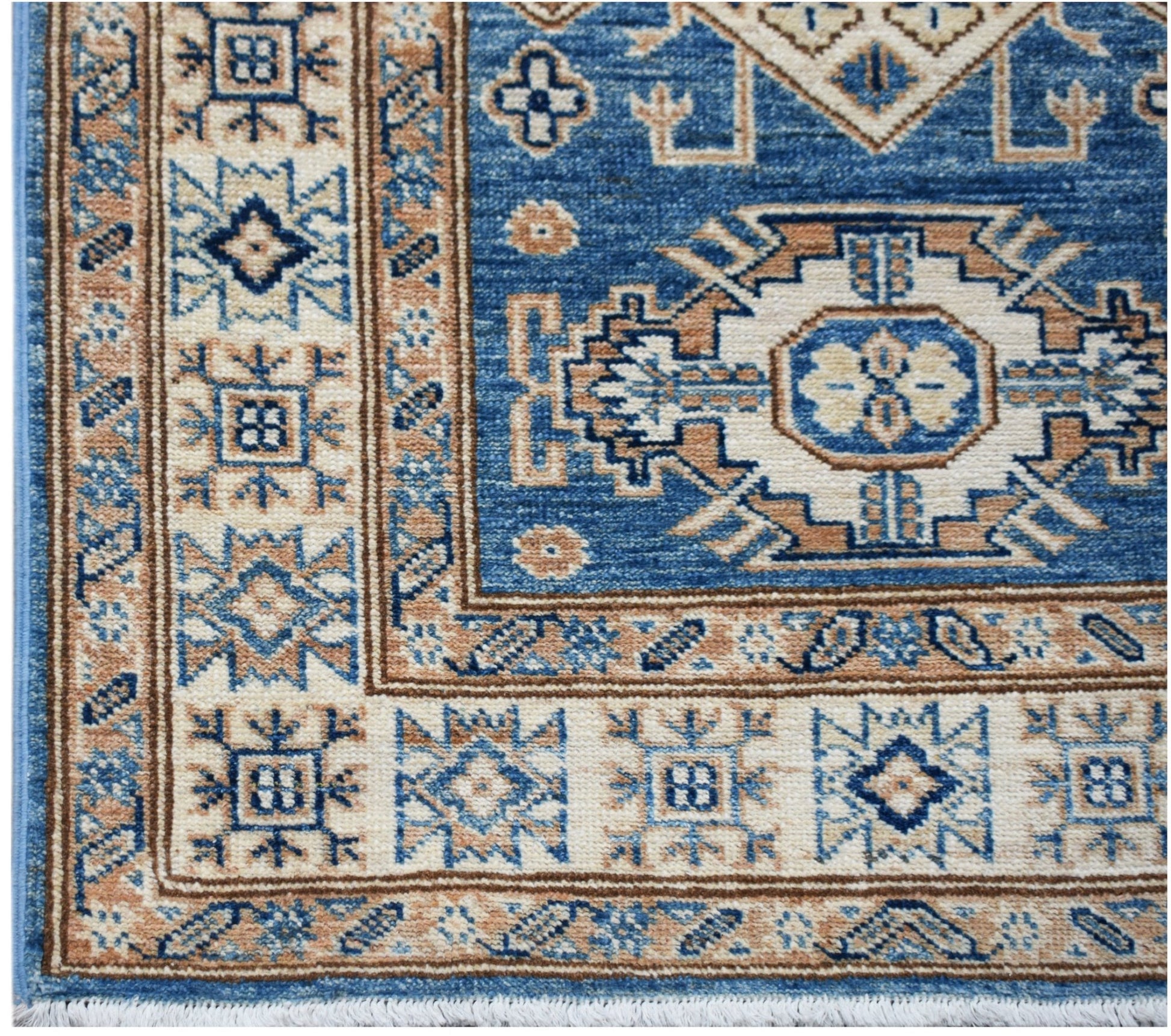 A handmade Afghan Super Kazakh runner featuring traditional blue and beige geometric motifs.