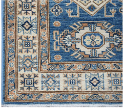 A handmade Afghan Super Kazakh runner featuring traditional blue and beige geometric motifs.