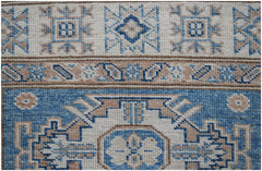 A handmade Afghan Super Kazakh runner featuring traditional geometric motifs in blue and beige.