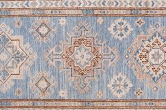 An Afghan Super Kazakh runner rug featuring traditional geometric motifs in blue and beige tones.