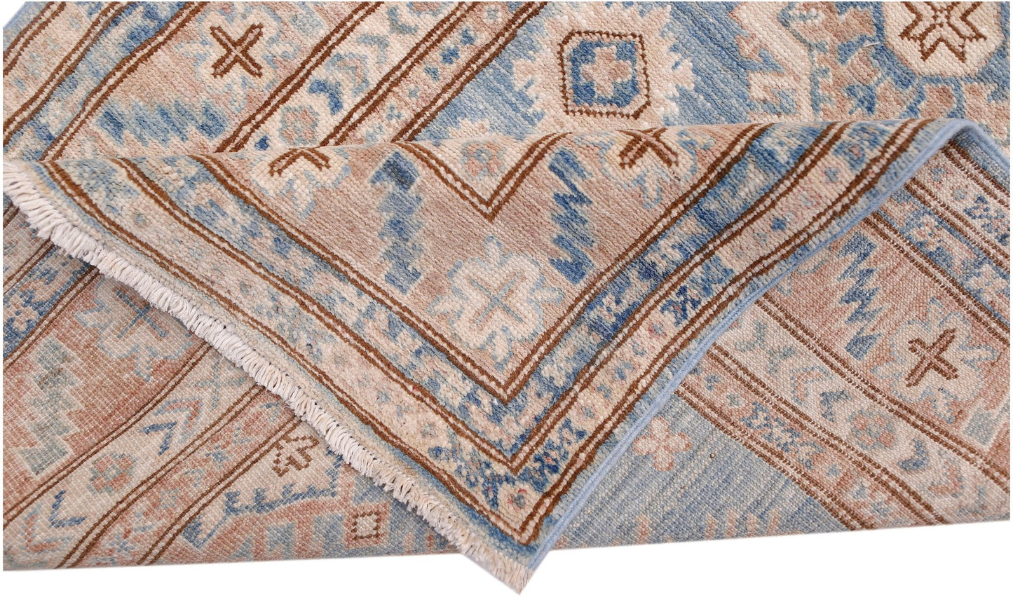 A handmade Afghan Super Kazakh runner featuring traditional geometric motifs in blue and beige.
