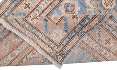 A handmade Afghan Super Kazakh runner featuring traditional geometric motifs in blue and beige.