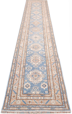 A long, handmade Afghan Super Kazakh runner rug featuring traditional geometric motifs in blue and tan.