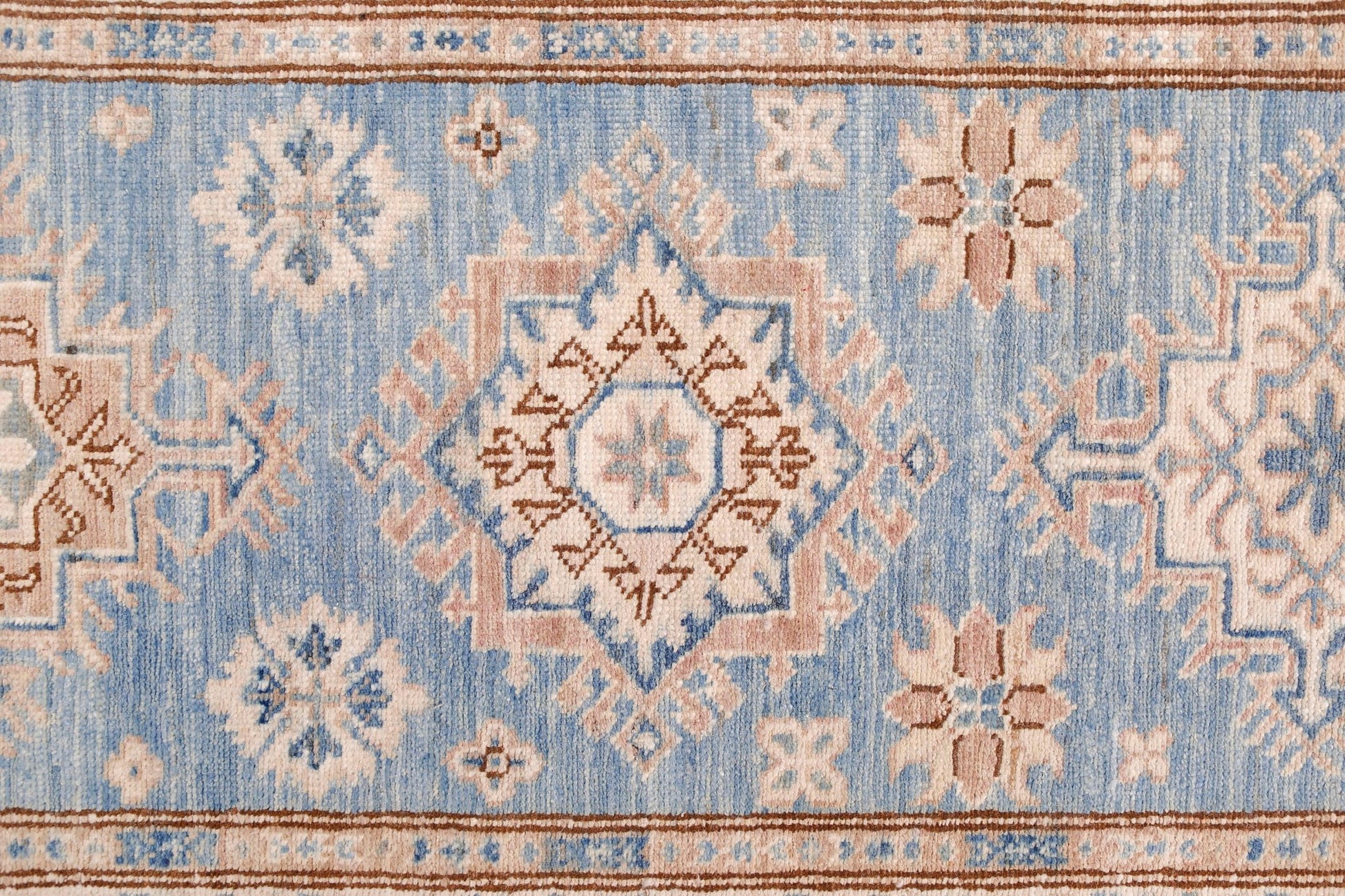 An Afghan Super Kazakh runner featuring traditional geometric motifs in blue, beige, and brown.