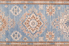 An Afghan Super Kazakh runner featuring traditional geometric motifs in blue, beige, and brown.
