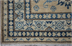 Handmade Afghan Super Kazakh runner featuring traditional blue and cream geometric patterns.