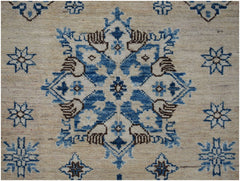 Handmade Afghan Super Kazakh runner featuring a central blue and brown floral medallion on beige.
