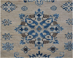 An Afghan Super Kazakh runner rug featuring a central blue and brown geometric floral medallion.