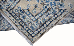 A handmade Afghan Super Kazakh runner featuring traditional blue and cream geometric patterns.