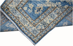 A handmade Afghan Super Kazakh runner rug featuring a blue and beige geometric pattern.