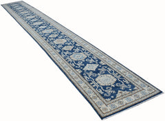 A long, handmade Afghan Super Kazakh runner rug featuring traditional blue and beige patterns.